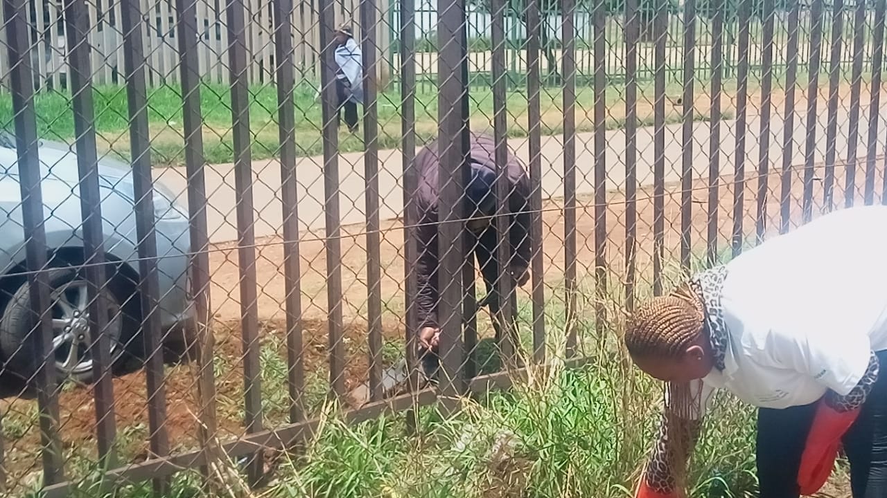 Men cleaning the resource centre with tools